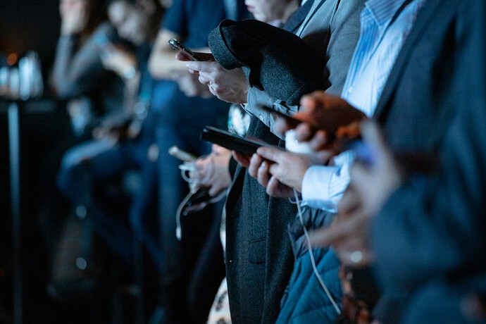 row-of-people-checking-their-phones